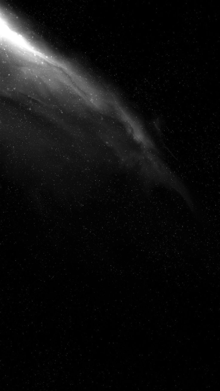 a black and white photo of a comet in the night sky with stars around it