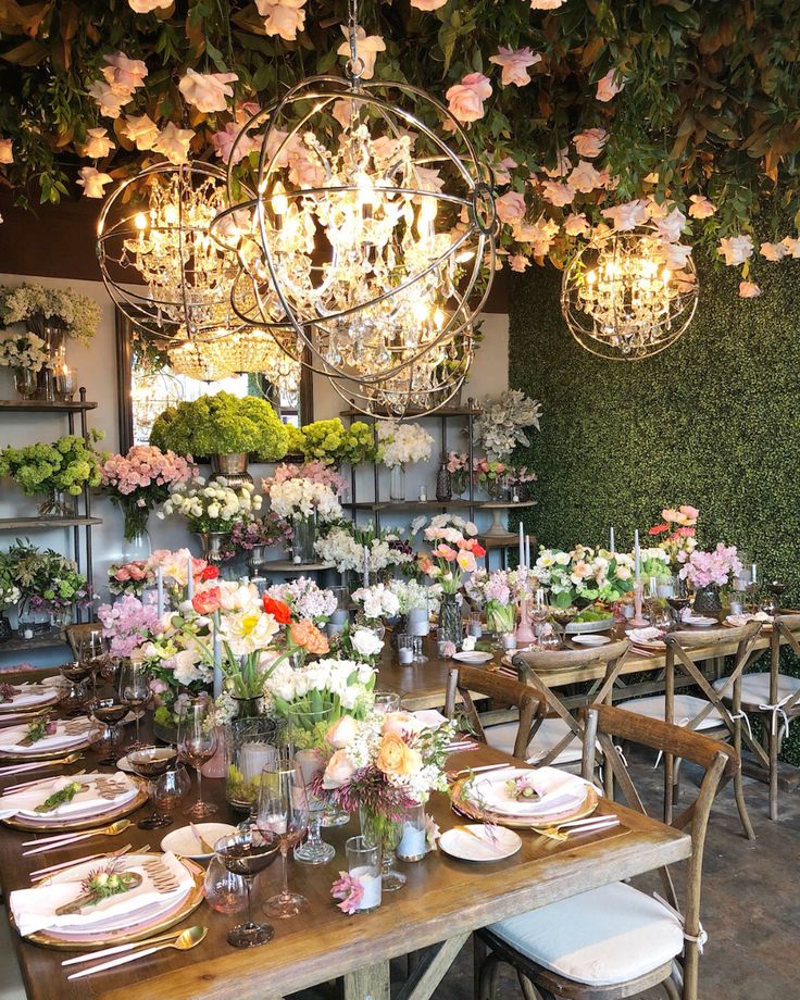 an instagram page with flowers and chandeliers on the wall above tables in a flower shop