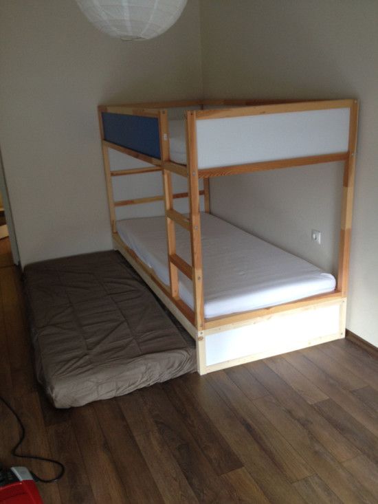 a bunk bed sitting on top of a wooden floor
