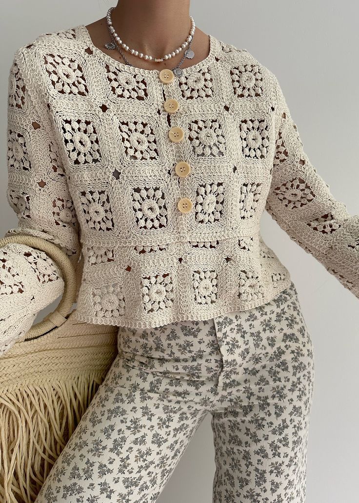 a woman in white sweater and patterned pants holding a wicker basket next to her