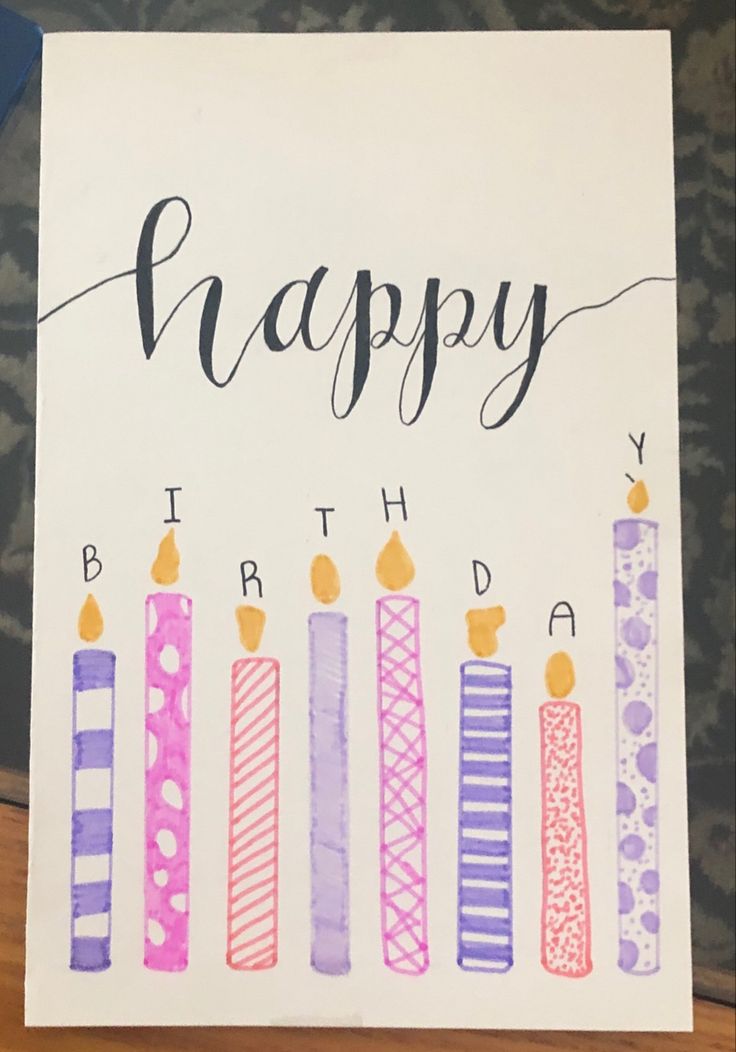 a birthday card with candles on it and the words happy written in cursive writing
