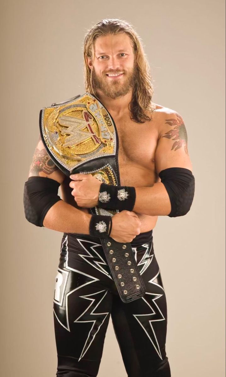 the wrestler is posing for a photo with his wrestling belt