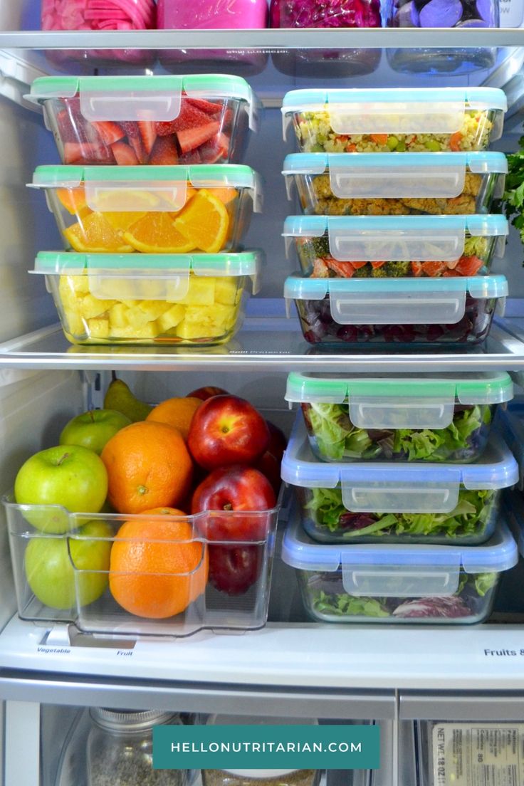 an open refrigerator filled with lots of different types of food in plastic containers on the shelves