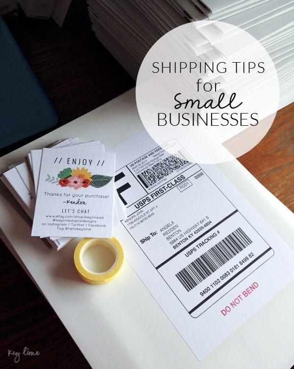 a stack of small business cards sitting on top of a table next to a cup