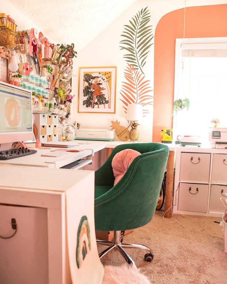 a desk with a computer on top of it in a room filled with drawers and other items