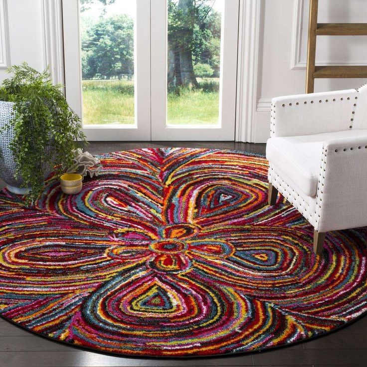 a living room with a chair and rug on the floor