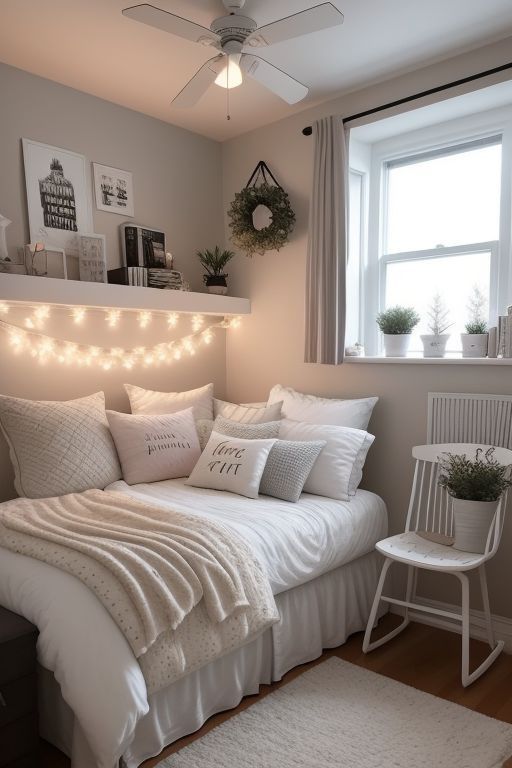 a white bed sitting in a bedroom next to a window with fairy lights on it