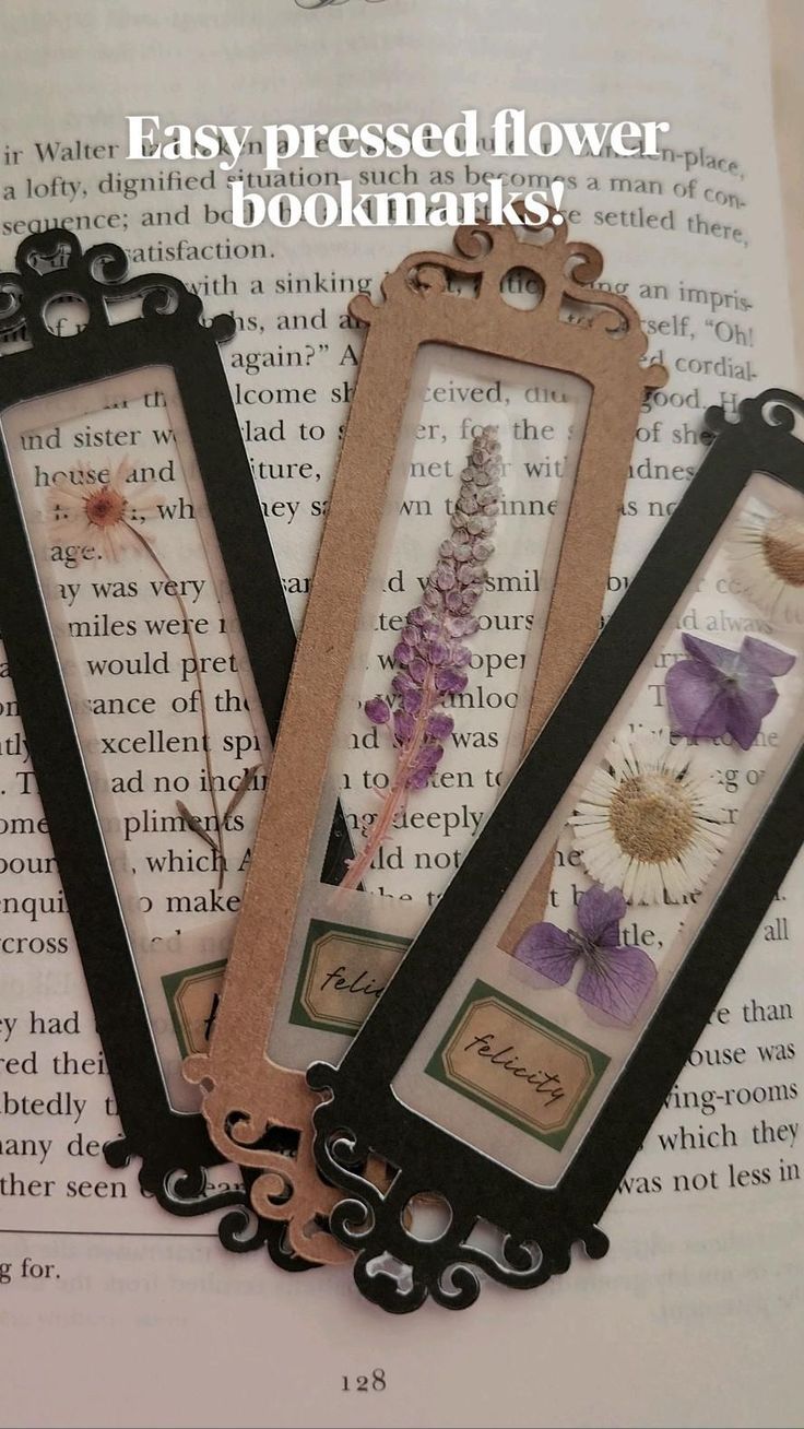 three bookmarks with flowers on them sitting on top of an open book page that reads easy pressed flower bookmarks