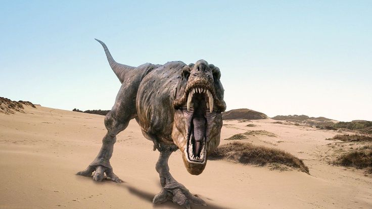 a dinosaur with its mouth open in the desert