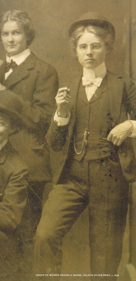 an old black and white photo of two boys in suits with hats on their heads