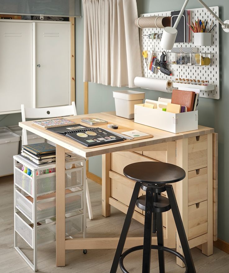 a desk with two stools in front of it