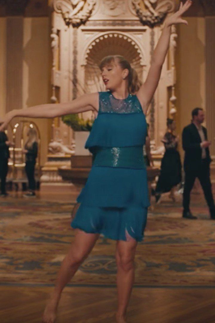 a woman in a blue dress is dancing