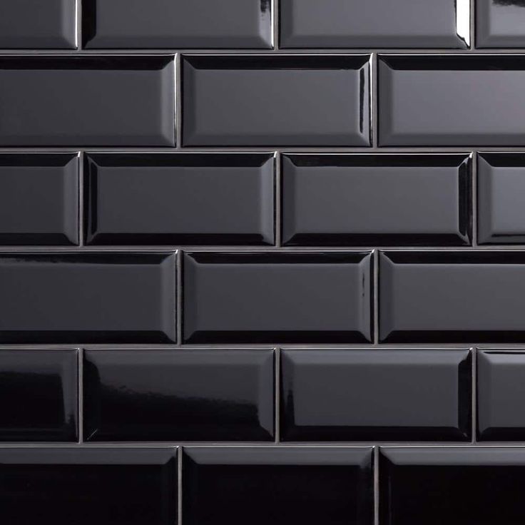 a black tile wall that is very close to the ground