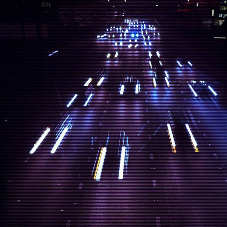 a city street filled with lots of traffic at night