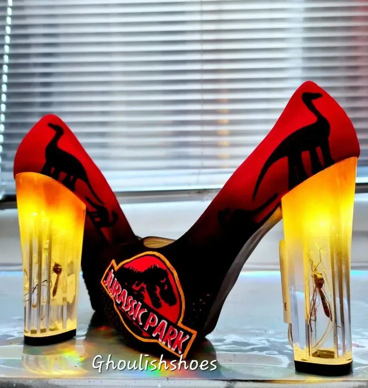 a pair of high heeled shoes sitting on top of a table next to a window