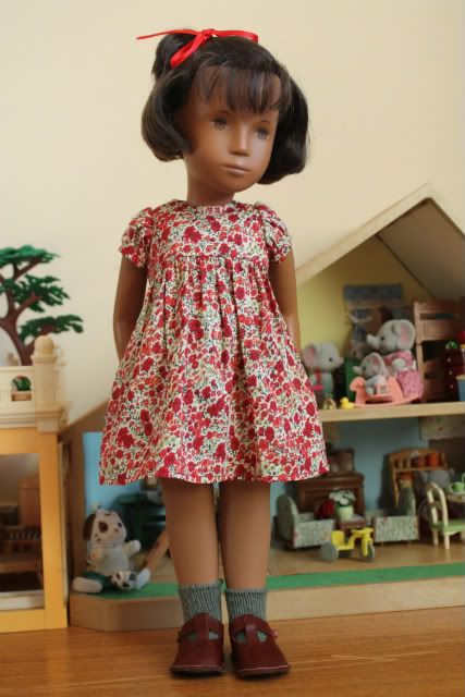 a doll is standing on the wooden floor