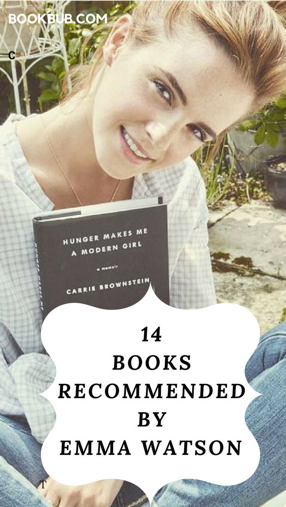 a woman sitting on the ground holding a book