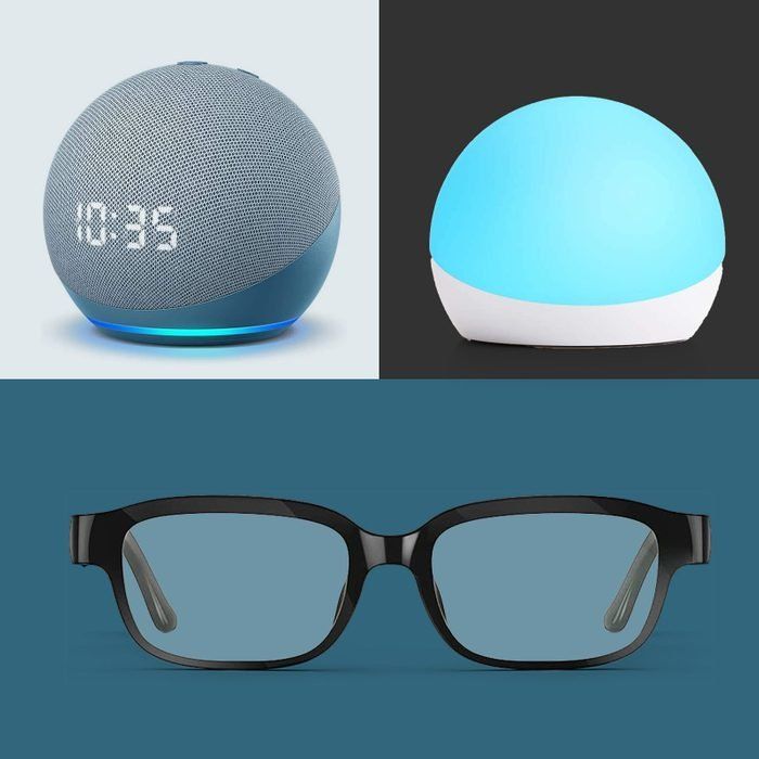 the glasses are next to an alarm clock, and there is a bluetooth speaker