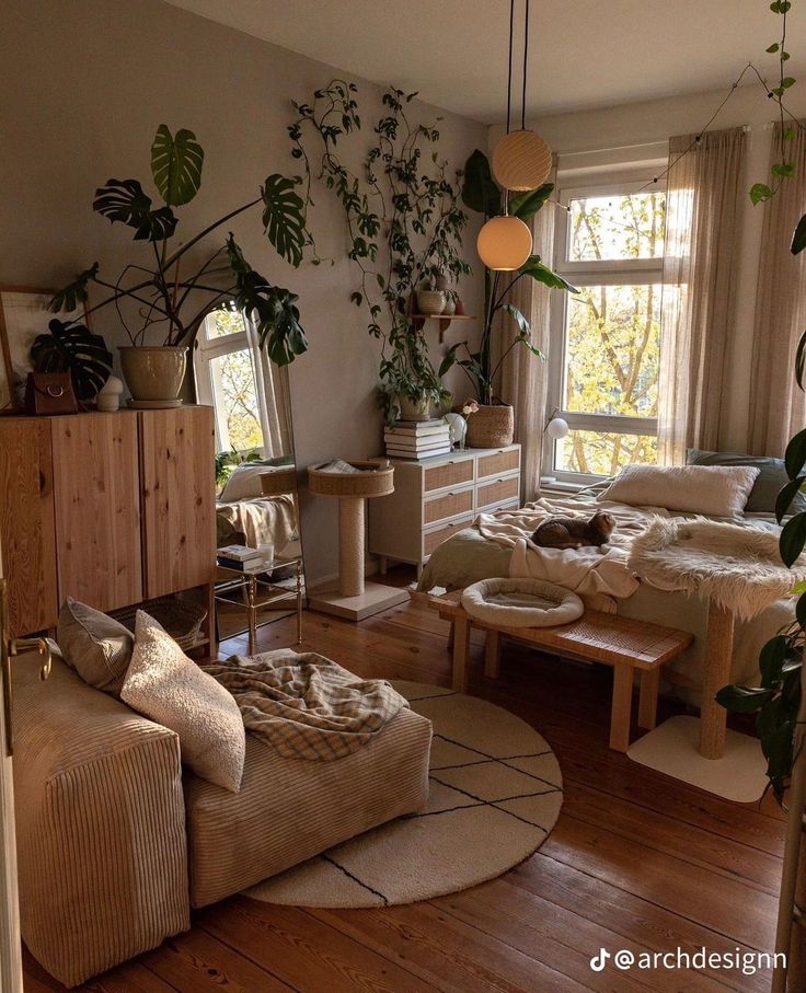 a living room filled with furniture and lots of plants