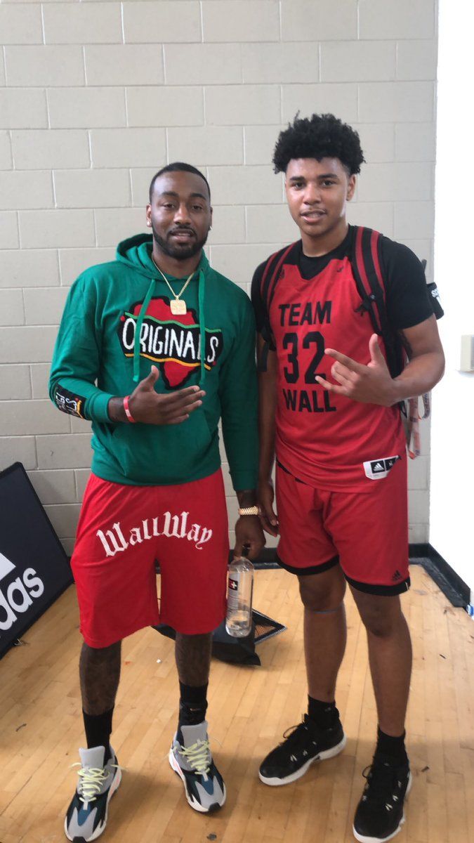 two young men standing next to each other in front of a wall with the words cleveland hawks on it