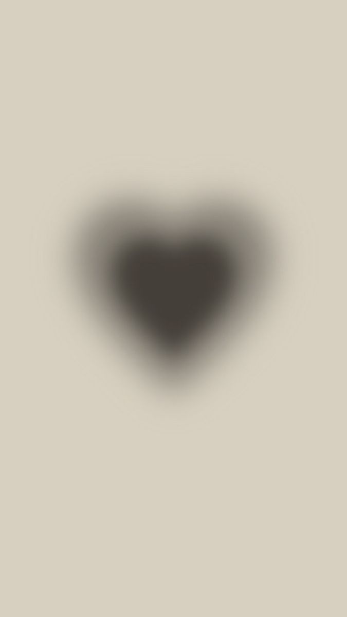 a black heart shaped object on a gray background