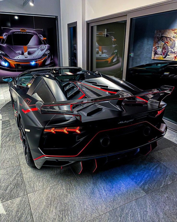 a black sports car parked inside of a garage