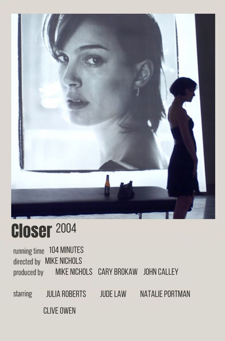 a woman standing in front of a large screen with the words closer written on it