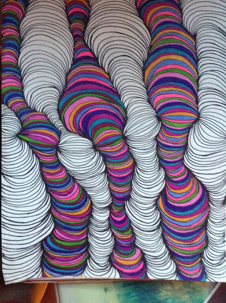 this is an art work with many different colored lines on the paper, and it looks like they are made out of yarn