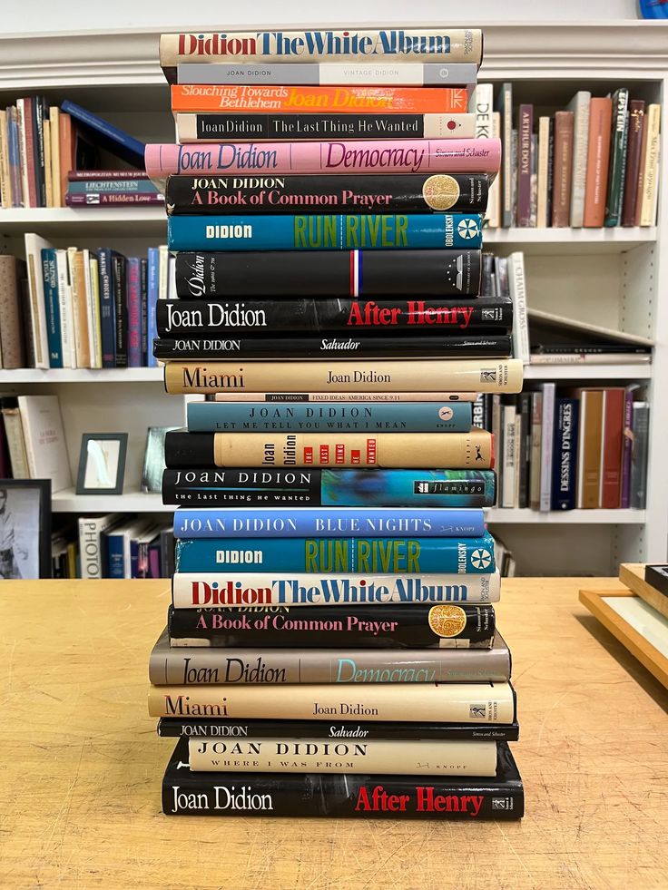 a stack of books sitting on top of a wooden table