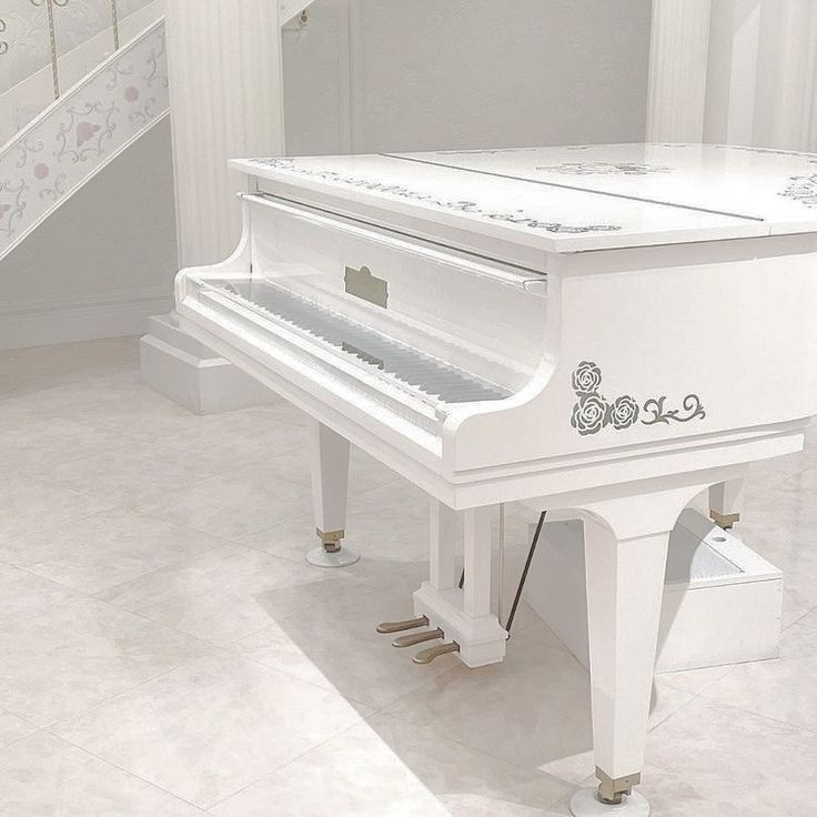 a white piano sitting in the middle of a room