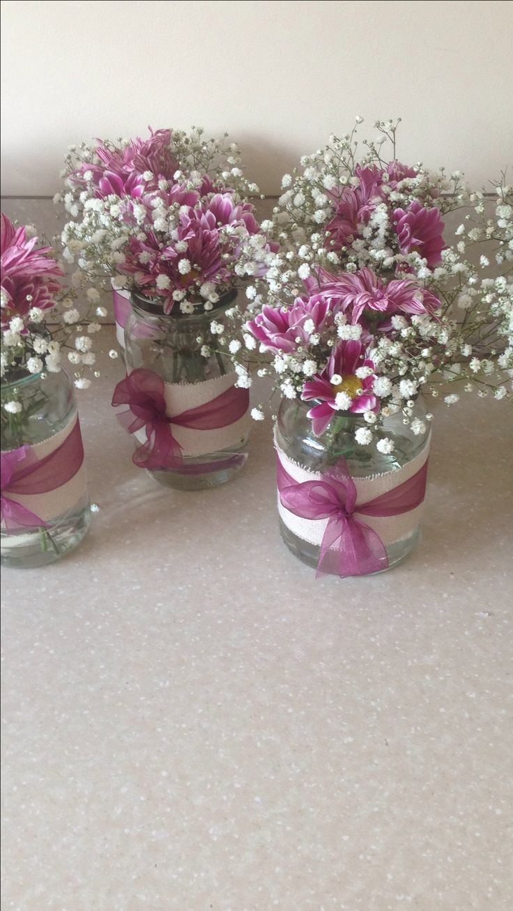 three mason jars filled with baby's breath flowers