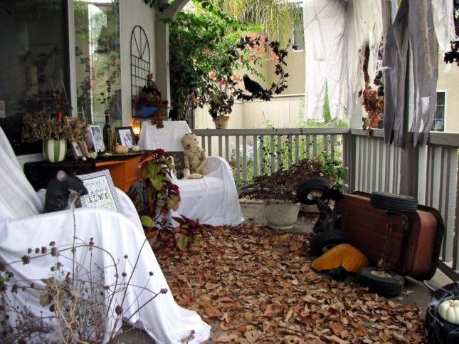 the porch is covered with leaves and other things that are left out on the ground