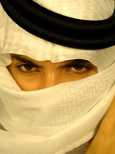 a person with a head scarf covering their face