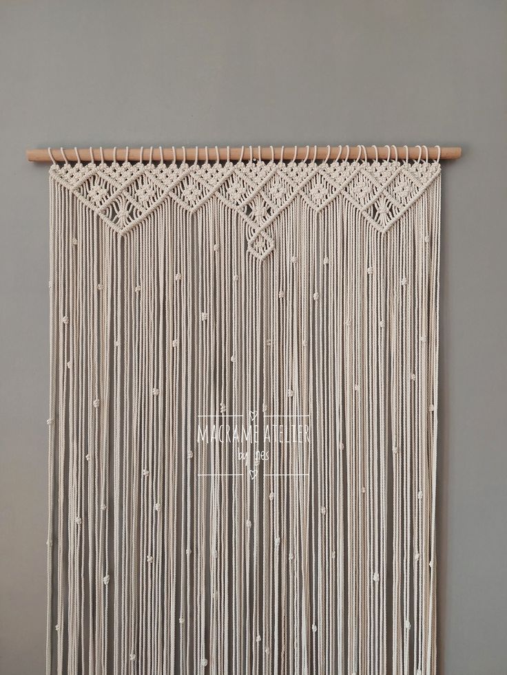 a wall hanging made out of macrame beads