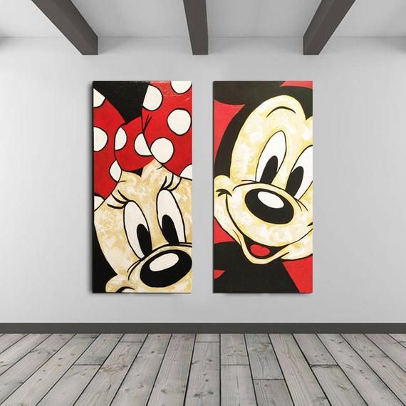 two mickey and minnie mouse paintings hanging on the wall in an empty room with wood flooring