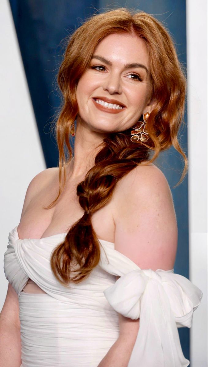 a woman with long red hair wearing a white dress