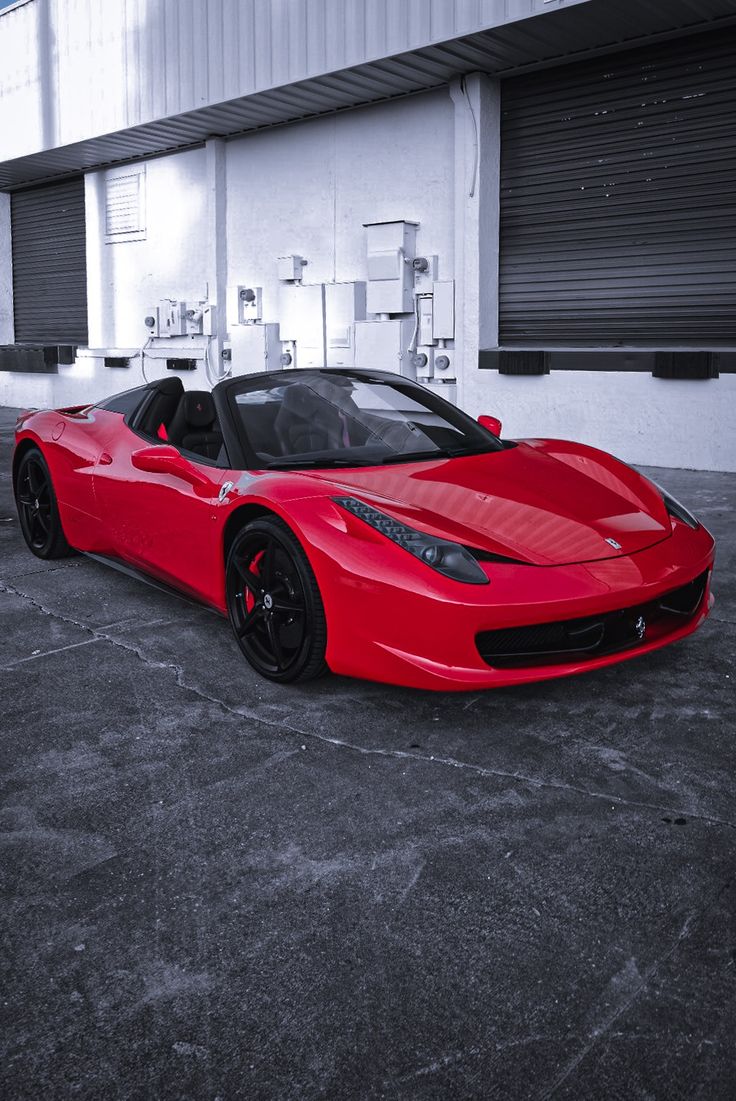 a red sports car parked in front of a building