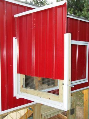 a red chicken coop with the door open