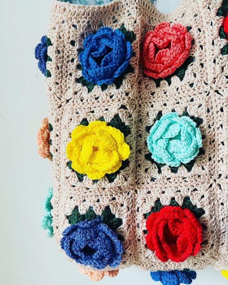 a crocheted purse with multicolored flowers on it