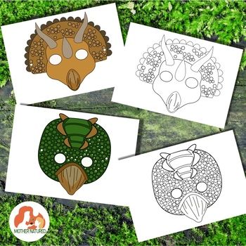 four masks with different designs on them sitting in the middle of some green plants and grass