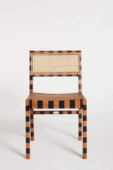 a chair made out of woven material with black and orange strips on the back side