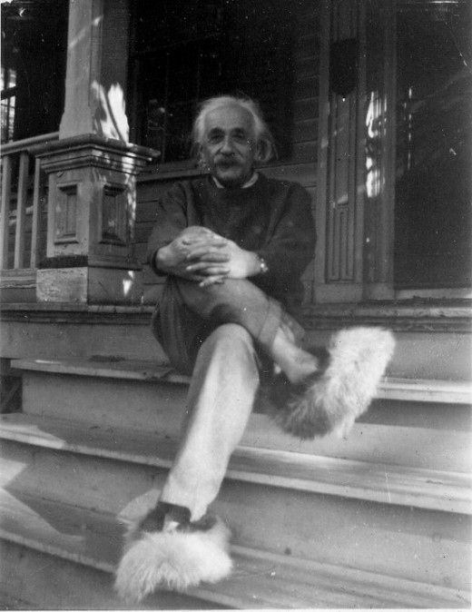 an old black and white photo of a man sitting on the steps