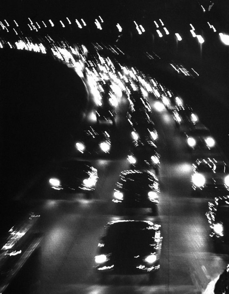 black and white photograph of traffic at night