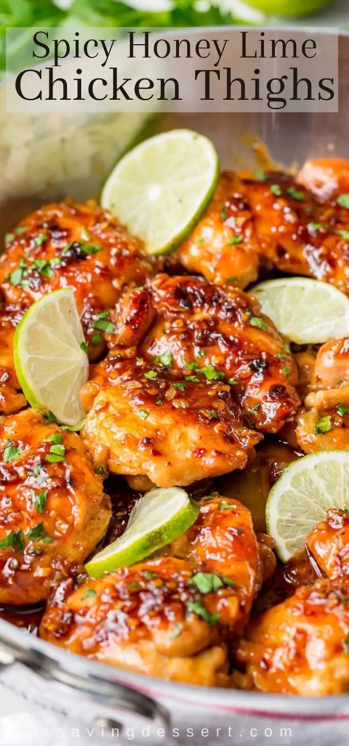 chicken thighs in a pan with limes and cilantro garnishes