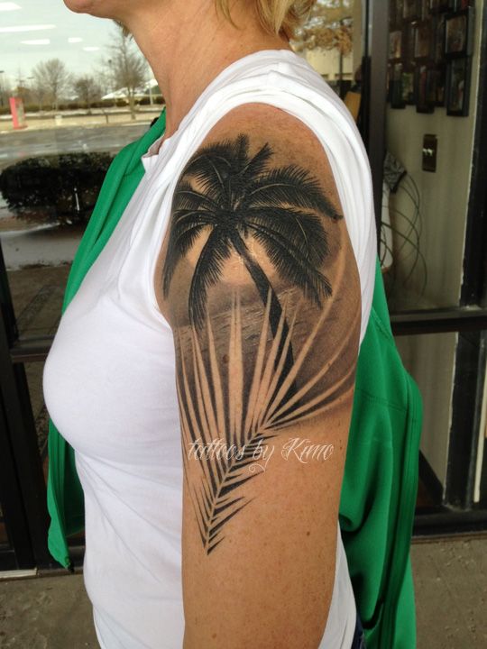 a woman with a palm tree tattoo on her arm and shoulder, in the middle of an instagram page