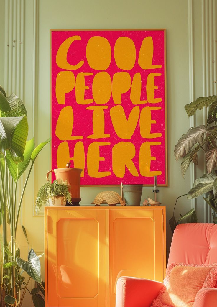 an orange chair in front of a pink poster with the words cool people live here