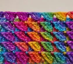 a multicolored crochet pattern on a white surface