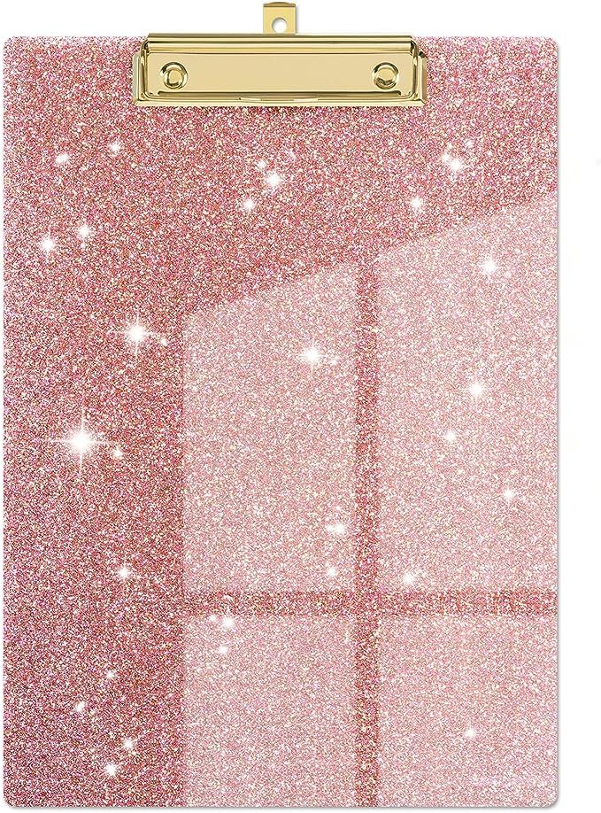 a pink clipboard with glitter on it and gold trimming around the edges, in front of a white background