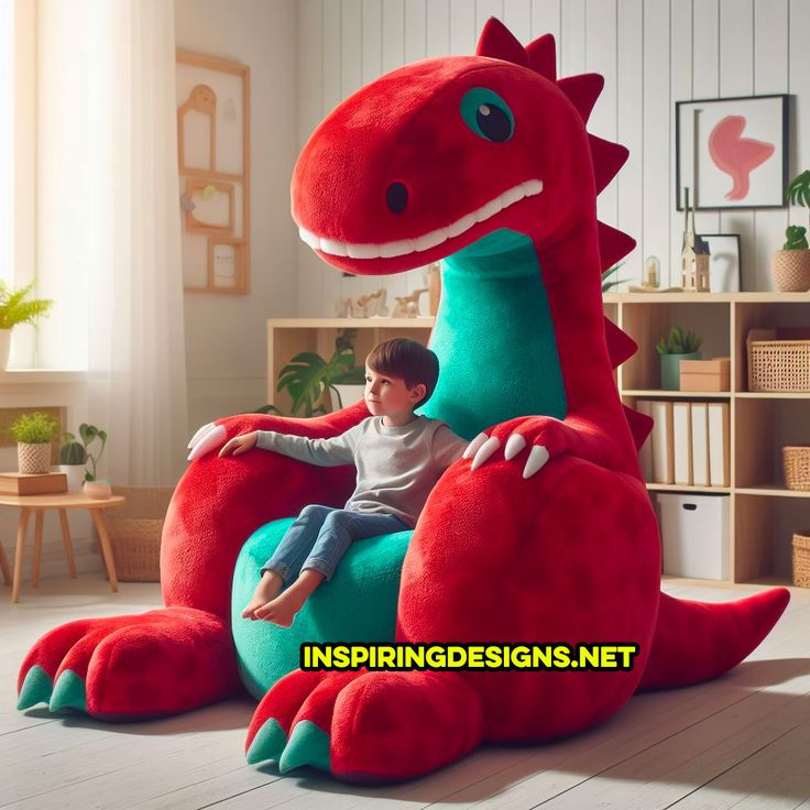 a young boy sitting on a large red dinosaur chair in the middle of a room