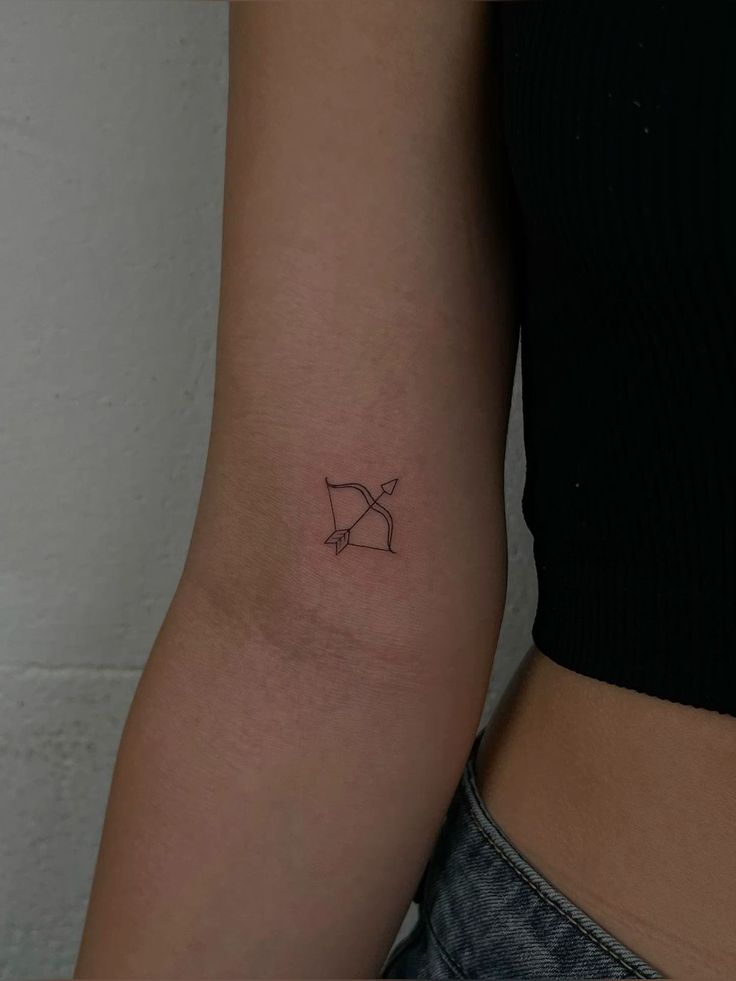 small tattoo inspo It Ends With Us Book Tattoo, Taylor Swift Tattoo Ideas The Archer, Dainty Tattoo Stencils, Sagittarius Behind The Ear Tattoo, Dainty Bow And Arrow Tattoo, Small Tattoo Ideas Taylor Swift, Small Archer Tattoo, Taylor Swift Tattoo Archer, Minimalistic Taylor Swift Tattoos